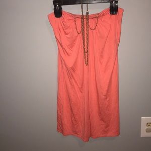 Cute coral sundress with necklace.